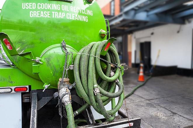 large truck pumping grease trap at a restaurant in Cohoes, NY